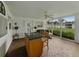 Enclosed porch with abundant natural light, features an island and comfortable seating areas at 140 Morrow Cir, Brandon, FL 33510