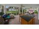 Large screened-in porch furnished with comfortable seating and offers island with bar stools and backyard views at 140 Morrow Cir, Brandon, FL 33510