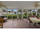 Enclosed porch with screened windows, a ceiling fan, and outdoor seating offers a tranquil space at 140 Morrow Cir, Brandon, FL 33510