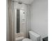 Shower with patterned curtains, black and white tiling, pebble shower floor and installed shelving at 140 Morrow Cir, Brandon, FL 33510