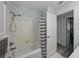 Bathroom featuring a white shower/tub combo with bronze fixtures and grey tile flooring at 140 Morrow Cir, Brandon, FL 33510
