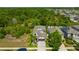 Aerial view of a lovely home nestled amidst lush greenery, offering privacy and tranquility at 14716 Crescent Rock Dr, Wimauma, FL 33598