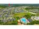 Aerial view of community with pool, green space, playground, and many single Gathering homes at 14716 Crescent Rock Dr, Wimauma, FL 33598