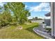 Lush backyard featuring a fire pit, string lights, a shed, and a wooded area at 14716 Crescent Rock Dr, Wimauma, FL 33598