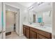 Bathroom with double vanity, wood cabinets, and neutral wall color at 14716 Crescent Rock Dr, Wimauma, FL 33598