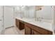 Bathroom featuring double vanity sinks and a shower at 14716 Crescent Rock Dr, Wimauma, FL 33598