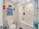 Bathroom includes a bathtub-shower combo with white tile surround at 14716 Crescent Rock Dr, Wimauma, FL 33598