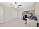 Bedroom featuring a ceiling fan and a built-in desk area with storage shelves at 14716 Crescent Rock Dr, Wimauma, FL 33598