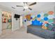 Bedroom view to walk-in closet with ceiling fan and hexagon decorations at 14716 Crescent Rock Dr, Wimauma, FL 33598