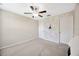 Bright bedroom with a ceiling fan, closet door, and stylish geometric accent wall at 14716 Crescent Rock Dr, Wimauma, FL 33598
