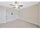 Spacious bedroom with a ceiling fan, closet door, and stylish geometric accent wall at 14716 Crescent Rock Dr, Wimauma, FL 33598
