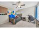 This bedroom features a ceiling fan and hexagon decorations on the wall at 14716 Crescent Rock Dr, Wimauma, FL 33598