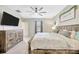 This bedroom offers a ceiling fan, television, and decor at 14716 Crescent Rock Dr, Wimauma, FL 33598