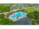 Community Pool with plenty of seating and lush landscaping for relaxing in style at 14716 Crescent Rock Dr, Wimauma, FL 33598
