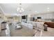 Open-concept dining area with large dining table and access to the kitchen and living room at 14716 Crescent Rock Dr, Wimauma, FL 33598