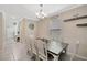 Bright dining room with a rustic wooden table and white chairs, perfect for Gathering gatherings at 14716 Crescent Rock Dr, Wimauma, FL 33598