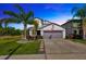 Charming two-story home with well-manicured lawn, landscaping and a two car garage at 14716 Crescent Rock Dr, Wimauma, FL 33598