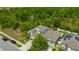 A modern two-story home with a beautiful lawn and green space creating a serene and private atmosphere at 14716 Crescent Rock Dr, Wimauma, FL 33598