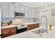 Bright kitchen featuring gray tile backsplash, white countertops, and stainless steel appliances at 14716 Crescent Rock Dr, Wimauma, FL 33598