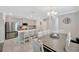 Spacious kitchen and dining area with a large island, modern appliances, and ample seating at 14716 Crescent Rock Dr, Wimauma, FL 33598