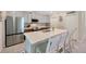 Bright kitchen featuring a large island, stainless steel appliances, and sleek white cabinets at 14716 Crescent Rock Dr, Wimauma, FL 33598