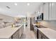 Open concept kitchen with stainless steel appliances, gray backsplash, and access to the living area at 14716 Crescent Rock Dr, Wimauma, FL 33598