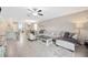Inviting living room with a large sofa, stylish rug, and seamless flow to other living spaces at 14716 Crescent Rock Dr, Wimauma, FL 33598