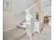 Inviting staircase with neutral carpet, adjacent to a stylish white dresser and decor at 14716 Crescent Rock Dr, Wimauma, FL 33598