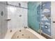 Bathroom featuring a soaking tub, unique glass art and cloud accents on the walls at 15000 Gulf Blvd # 407, Madeira Beach, FL 33708
