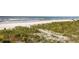 Picturesque beach view with ocean, dunes, and beach grass at 15000 Gulf Blvd # 407, Madeira Beach, FL 33708