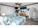 This bedroom is furnished with two beds, and decorated with tropical wallpaper and coastal accents at 15000 Gulf Blvd # 407, Madeira Beach, FL 33708