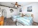 Comfortable bedroom featuring two twin beds, nautical décor, and ample natural light at 15000 Gulf Blvd # 407, Madeira Beach, FL 33708
