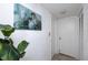 Hallway with a plant, neutral tile flooring, and a white closet door at 15000 Gulf Blvd # 407, Madeira Beach, FL 33708
