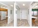 Bright condo hallway with mirrored closet doors and a view of the kitchen with a breakfast nook at 15000 Gulf Blvd # 407, Madeira Beach, FL 33708