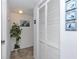 Bright hallway with tiled floors, closet, and coastal-themed decor at 15000 Gulf Blvd # 407, Madeira Beach, FL 33708
