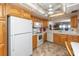Bright kitchen featuring tile floors, white appliances, and wood cabinets at 15000 Gulf Blvd # 407, Madeira Beach, FL 33708
