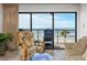 Living room area with comfortable seating, large windows, and an ocean view at 15000 Gulf Blvd # 407, Madeira Beach, FL 33708