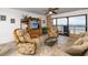 Cozy living room features comfortable seating, a large window with ocean views, and a ceiling fan at 15000 Gulf Blvd # 407, Madeira Beach, FL 33708