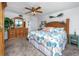This primary bedroom features a ceiling fan, a dresser with a mirror, and stylish coastal decor at 15000 Gulf Blvd # 407, Madeira Beach, FL 33708