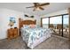 Cozy bedroom featuring a comfortable bed, a nightstand, and access to a balcony with ocean views at 15000 Gulf Blvd # 407, Madeira Beach, FL 33708