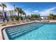 Enjoy a clear view of the swimming pool with blue umbrellas and lounge chairs in the Florida sun at 15000 Gulf Blvd # 407, Madeira Beach, FL 33708