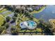 Aerial view of the community pool, playground, basketball and tennis courts, and pond at 15709 Leatherleaf Ln, Land O Lakes, FL 34638