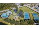 Aerial view showcasing the community's pool, tennis court, basketball court, and playground at 15709 Leatherleaf Ln, Land O Lakes, FL 34638