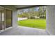 View of the spacious backyard from the covered patio with sliding glass door access to the interior at 15709 Leatherleaf Ln, Land O Lakes, FL 34638