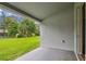 View of the lush green backyard from the covered patio; a perfect place to relax and enjoy the outdoors at 15709 Leatherleaf Ln, Land O Lakes, FL 34638
