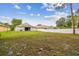 View of the backyard with a white fence enclosing the green space and the exterior of the home at 15709 Leatherleaf Ln, Land O Lakes, FL 34638
