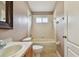 Cozy bathroom featuring a shower-tub combo, neutral tile, and stylish fixtures at 15709 Leatherleaf Ln, Land O Lakes, FL 34638