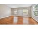 Bright bedroom with wood floors, large windows, and neutral walls at 15709 Leatherleaf Ln, Land O Lakes, FL 34638