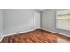 Bedroom featuring wood-look floors, a closet and window at 15709 Leatherleaf Ln, Land O Lakes, FL 34638