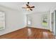 A bright bedroom offers great natural light through large windows and features a ceiling fan at 15709 Leatherleaf Ln, Land O Lakes, FL 34638